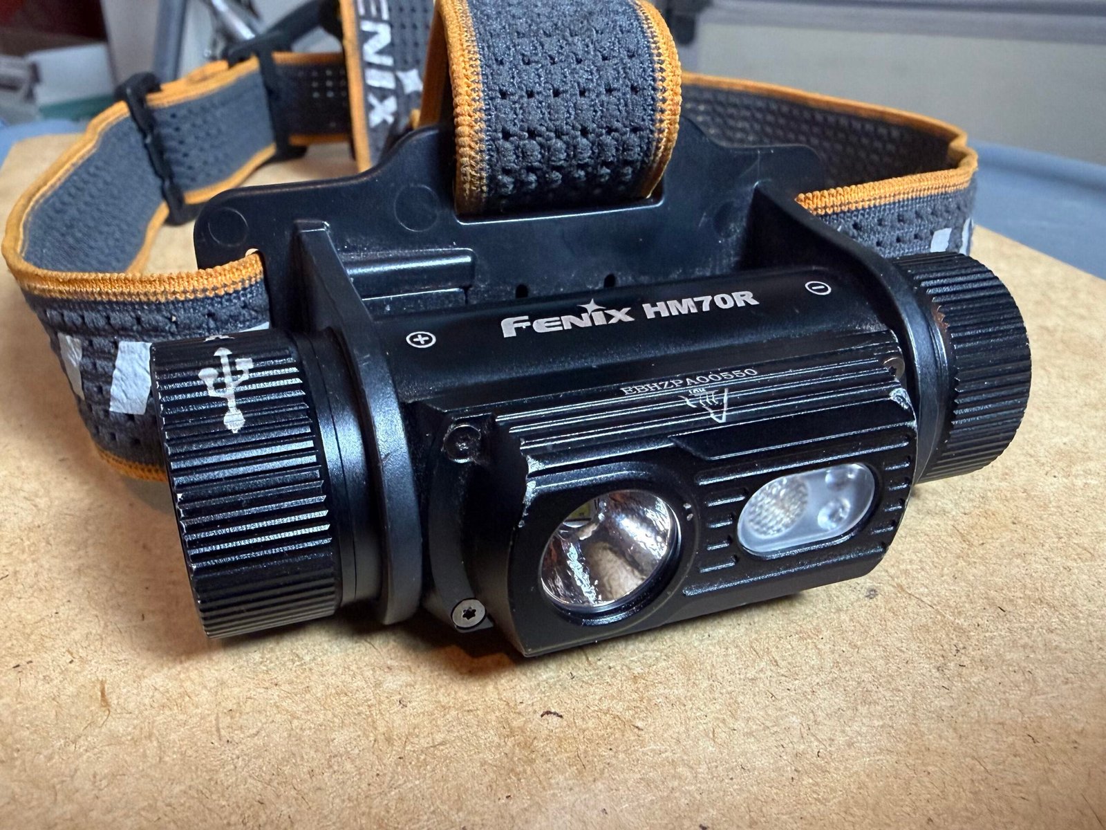 Fenix HM70R headlamp sitting on table