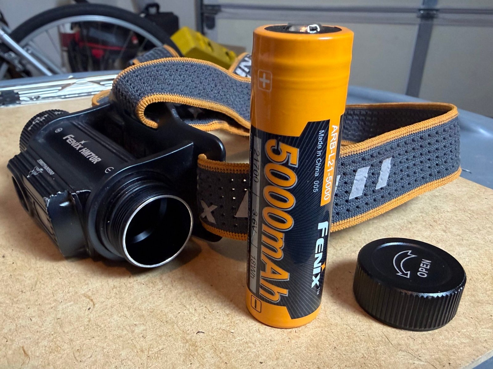 Fenix HM70R with battery cap off and battery standing up